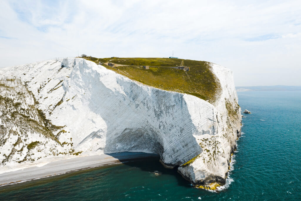 Photo of a white cliff surrounded by ocean